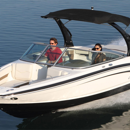 A couple walking on a boat by a lake