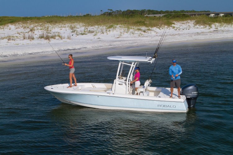A family fishing on a boat Robalo on the shore of the beach