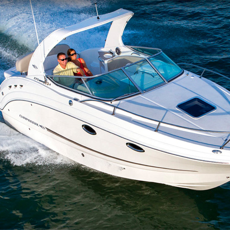 A couple walking on a Chaparral boat by a lake